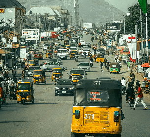 Busy street street with yellow tricycles